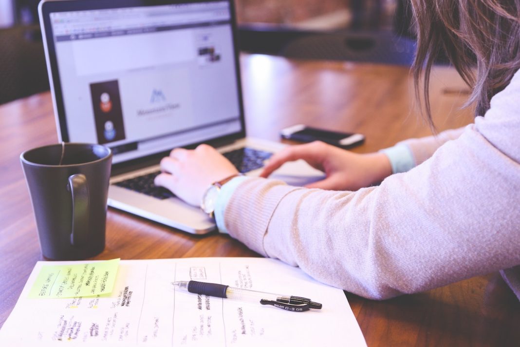 Image of business professional working on a laptop. Meant to symbolize affordable marketing strategies for small businesses.