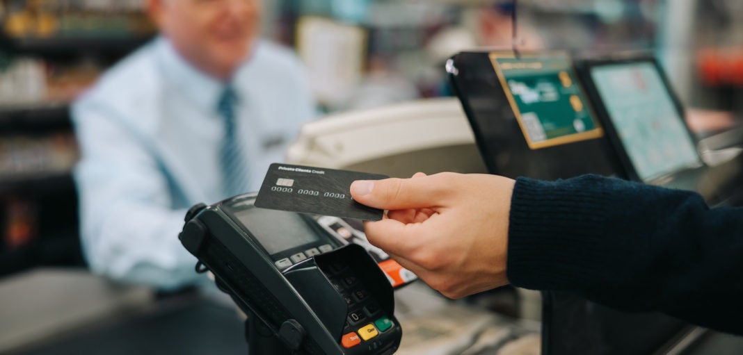 Image of customer paying at a point of sale (POS) system.